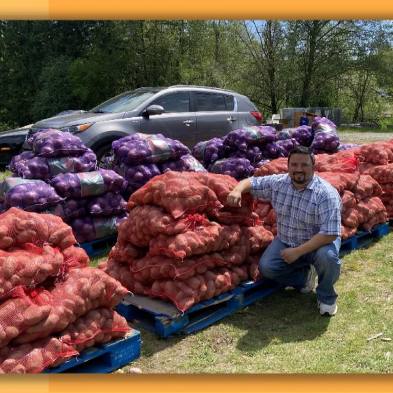 East West Food Rescue founder in front of rescued crops