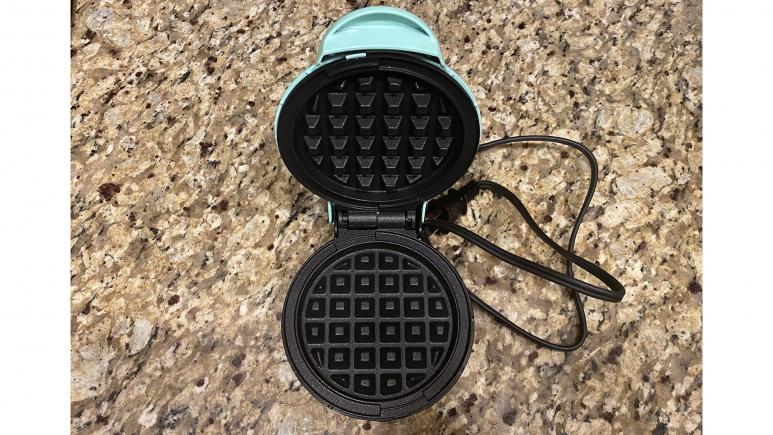 The inside of the Dash Mini Waffle Maker in Aqua