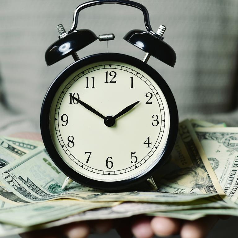 clock on pile of money