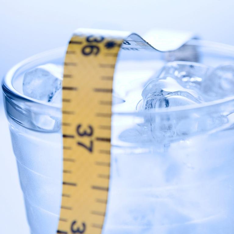 glass of water with measuring tape